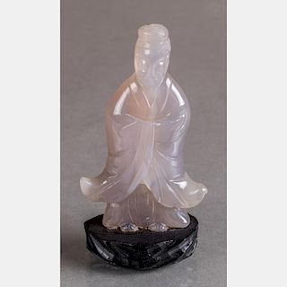 A Chinese Carved Agate Figure of an Elder on a Carved Hardwood Stand.