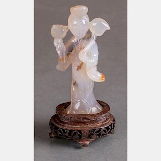 A Chinese Carved Agate Figure of Guanyin on Carved a Hardwood Stand.