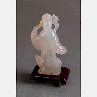 A Chinese Carved Agate Figure of Guanyin on a Carved Hardwood Stand.