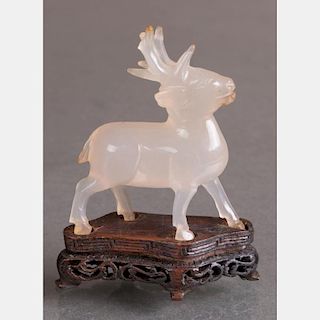 A Chinese Carved Agate Stag on a Carved Hardwood Stand.