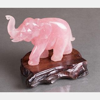 A Chinese Carved Rose Quartz Elephant Figure on a Carved Hardwood Stand.