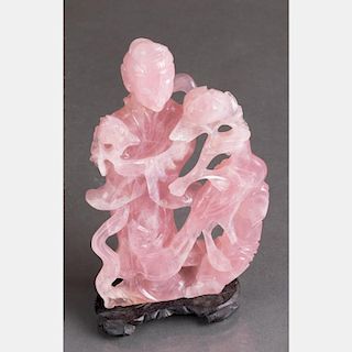 A Chinese Carved Rose Quartz Figure of Guanyin on a Carved Hardwood Stand.