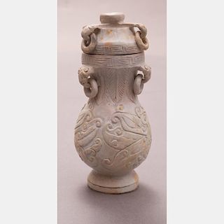 A Chinese Archaistic Style Carved Calcified Jade Vase and Cover.