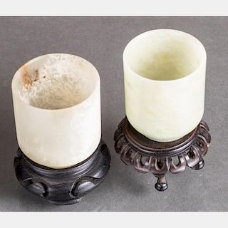 Two Chinese Carved Jade Cups on Carved Hardwood Stands.