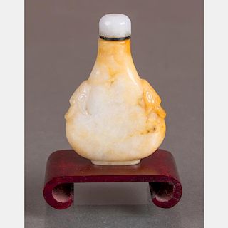 A Carved Jade Snuff Bottle with White Jade Stopper on Carved Hardwood Stand,