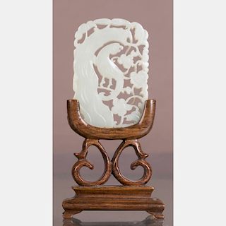 A Chinese Carved White Jade Pendant on a Carved Rosewood Stand.