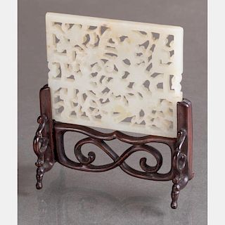 A Chinese Carved White Jade Table Screen on a Carved Rosewood Stand.