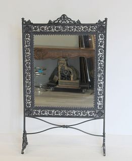 A Victorian Patinated Iron Mirrored Screen.