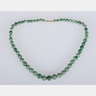A Graduated Green Jade Beaded Necklace,