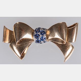 An 18kt. Yellow and White Gold Sapphire Bow Form Brooch,