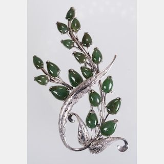 A 14kt. White Gold and Emerald Brooch.