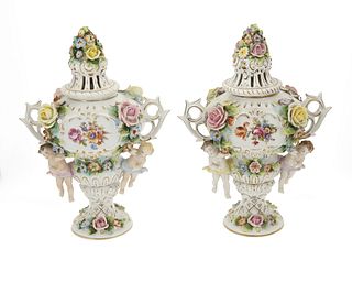A pair of Sitzendorf figural porcelain covered urns