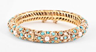 A custom made 14 karat gold bracelet set with turquoise and pearls