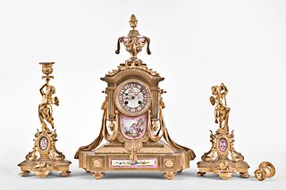 A late 19th century Louis XVI style clock garniture with decorative porcelain panels
