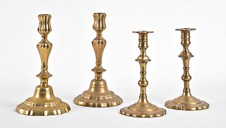 A lot of two pair of 18th century English brass candlesticks