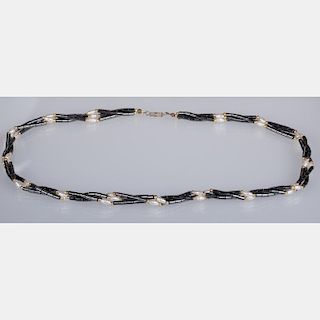 A Hematite, Pearl and Gold Beaded Necklace.