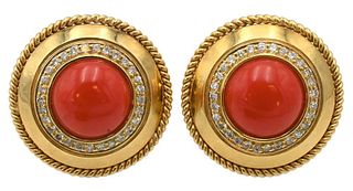 Pair of Round 14 Karat Ear Clips, having coral stone surround with diamond's, marked 14K, 20.8 grams.