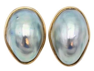 Pair of 14 Karat Gold Tambetti Ear Clips, having oval mother of pearl with 14 karat gold mounts.