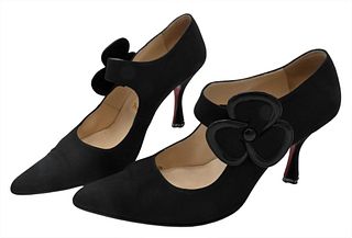 Pair of Christian Louboutin Shoes/Pumps, black with flower snap, having red bottoms.