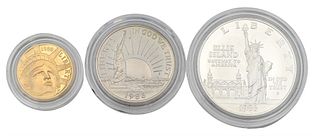 Three Piece 1986 Proof Statue of Liberty Set, to include five dollar gold, one copper nickel half dollar, along with one silver dollar.