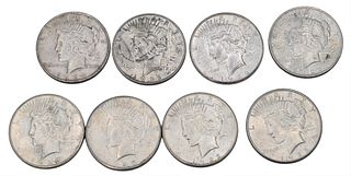 Eight Peace Silver Dollars.