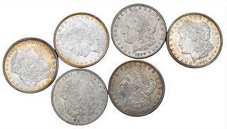 Six Morgan Silver Dollars, to include two 1882 uncirculated Morgan silver dollars.