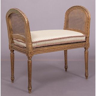 A Louis XVI Style Gilt Carved Bench with Caned Seat and Arms, 20th Century.