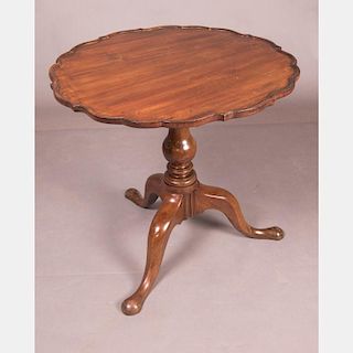 A Chippendale Style Mahogany Tilt-Top Tea Table with a Pie-Crust Edge, 20th Century.