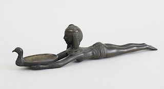EGYPTIAN STYLE BRONZE FIGURE OF A RECLINING SLAVE GIRL HOLDING A DUCK-HEADED BOWL