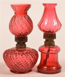 Two Cranberry Glass Miniature Fluid Lamps.