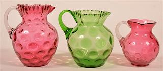 Three Colored Glass Coin Dot Pattern Pitchers.