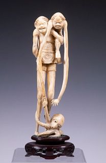 JAPANESE WHALE BONE CARVING OF TWO MYTHICAL FIGURES WITH OCTOPUS