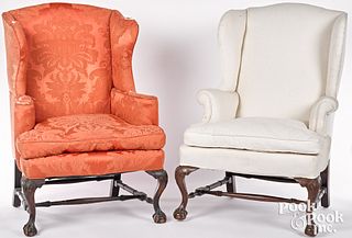 Two similar George III style carved wing chairs