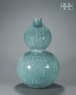 A celadon glazed porcelain gourd-shaped vase