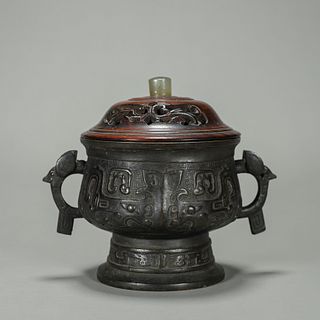 A taotie patterned copper pot with jade-inlaid wood lid