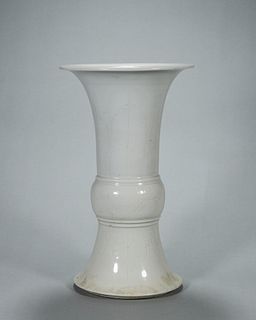 A banana leaf and flower carved white glazed porcelain beaker vase