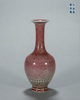 A red glazed porcelain daisy petal vase