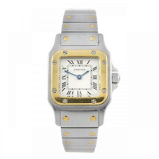 CARTIER - a Santos bracelet watch. Stainless steel case with yellow metal bezel. Numbered 1057930 05