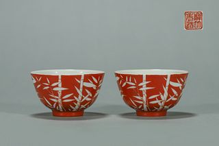 A pair of iron red ground white bamboo porcelain cups