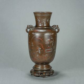 A figure patterned copper and silver vase with beast shaped ears