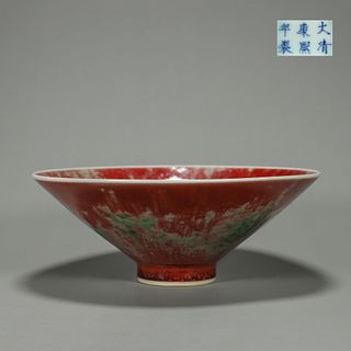 A red porcelain hat shaped cup