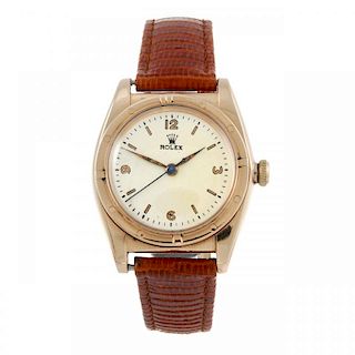 ROLEX - a gentleman's Bubble Back wrist watch. Circa 1947. Rose metal case, engine turned bezel, sta
