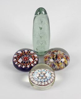 A group of four paperweights, the first possibly Old English, having three concentric bands of mille