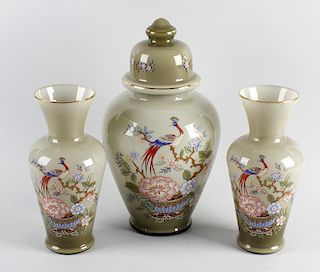 A garniture of three glass vases, comprising a large vase of ovoid form having domed cover plus a sm