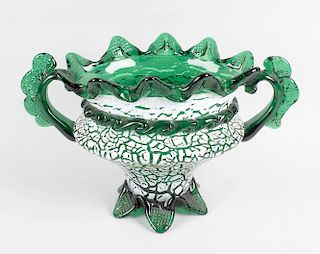 An enamelled green glass vase. Probably Bohemian, of oval form with crimped wavy rim over twin handl