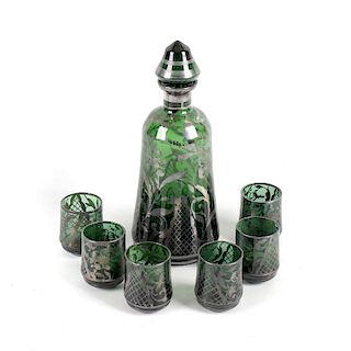 A Dutch green glass liqueur set, comprising decanter and six glasses each having floral decoration w