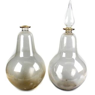 Two large blown glass apothecary or carboy display bottles, each of bulbous form, one with spire for