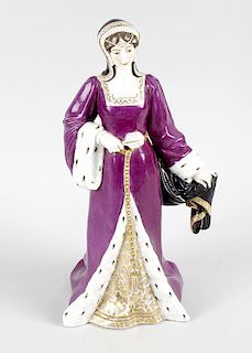 A late 19th century porcelain figure, probably French, modelled as a Queen wearing purple dress with