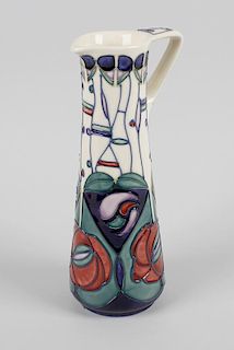 A Moorcroft pottery ewer, the tapered body with angular shaped handle, the tube lined decoration up