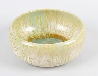 A Ruskin style pottery bowl, of circular form with merging drip green, brown and cream glaze, decora
